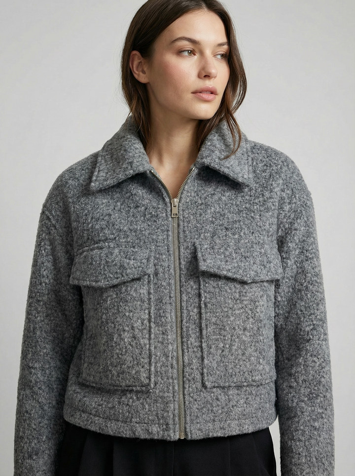 Women's gray cropped zip jacket with practical front pockets, perfect for casual spring fashion and layering.