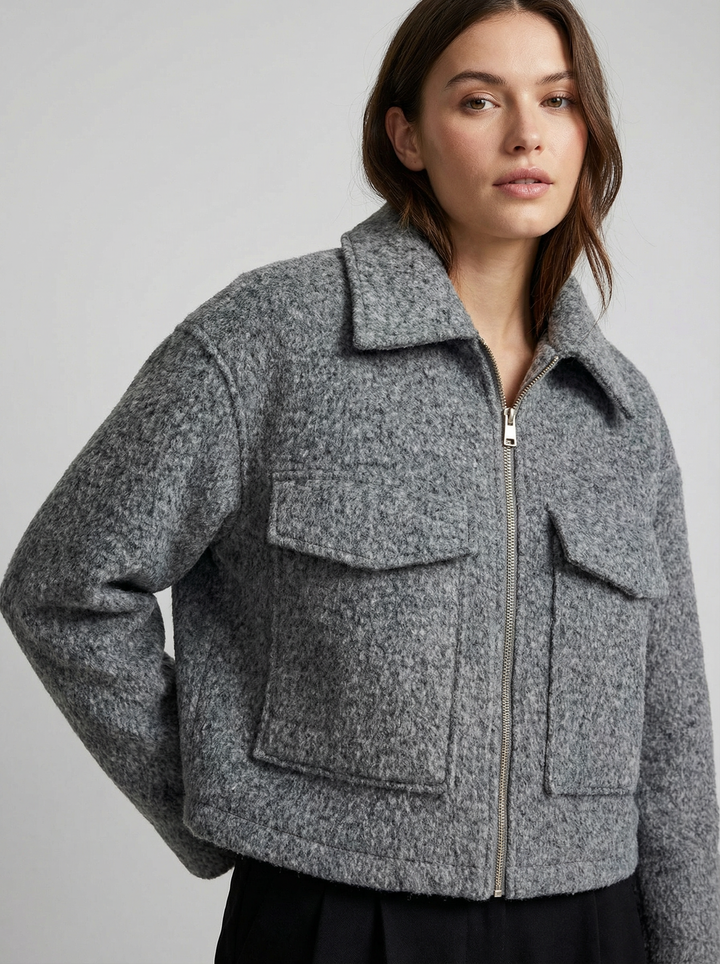 Chic women's gray cropped jacket with a front zip and handy pockets. Great for casual chic layering in any season.