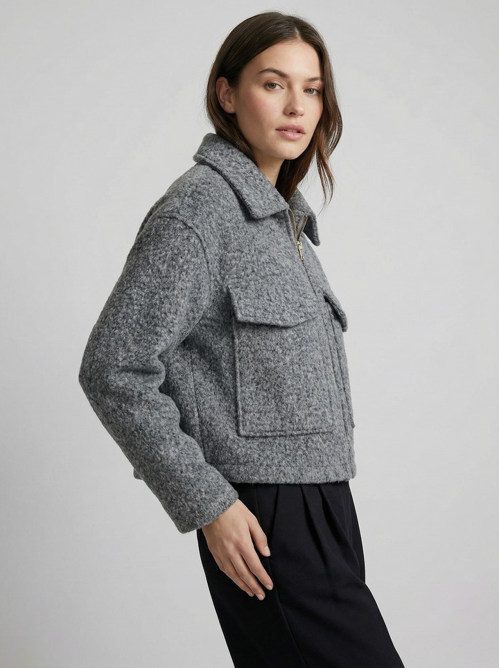 Gray women's cropped zip jacket. Features front pockets, a stylish outerwear piece for spring and autumn layering.
