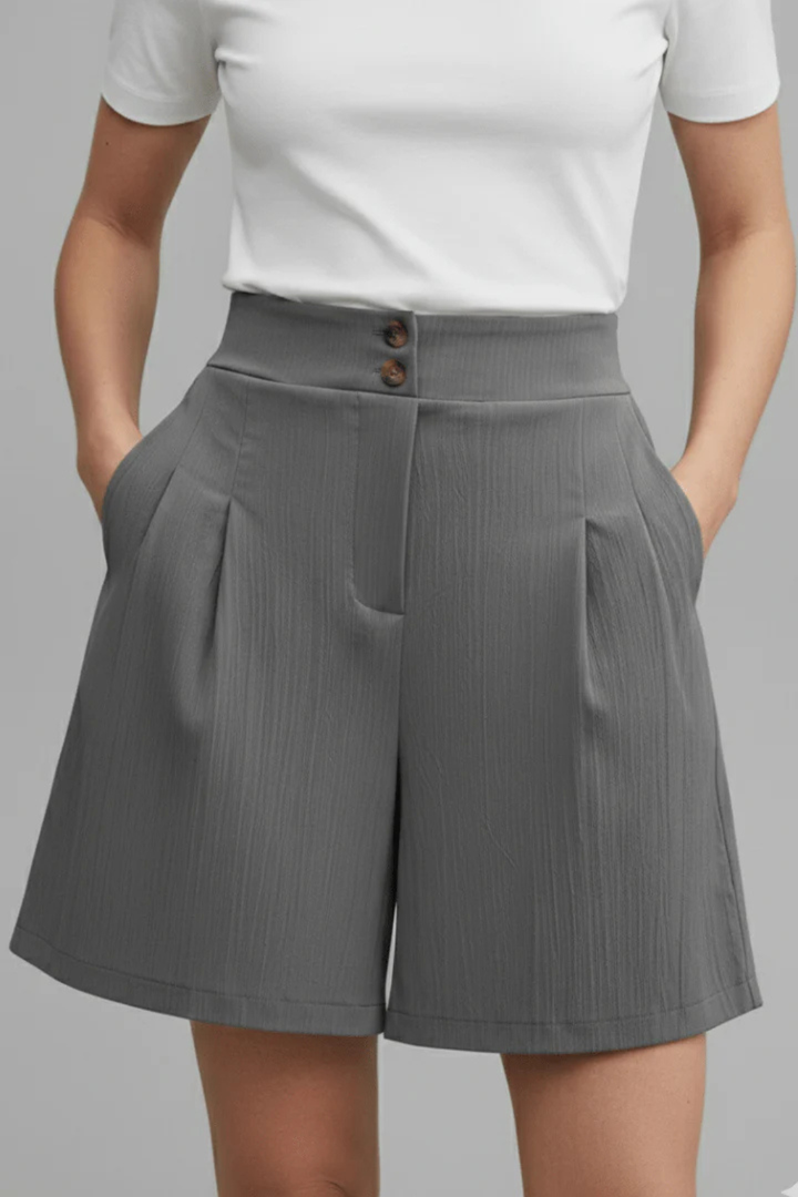 Casual high-waist Bermuda shorts for women featuring stylish pleats & wide leg design.