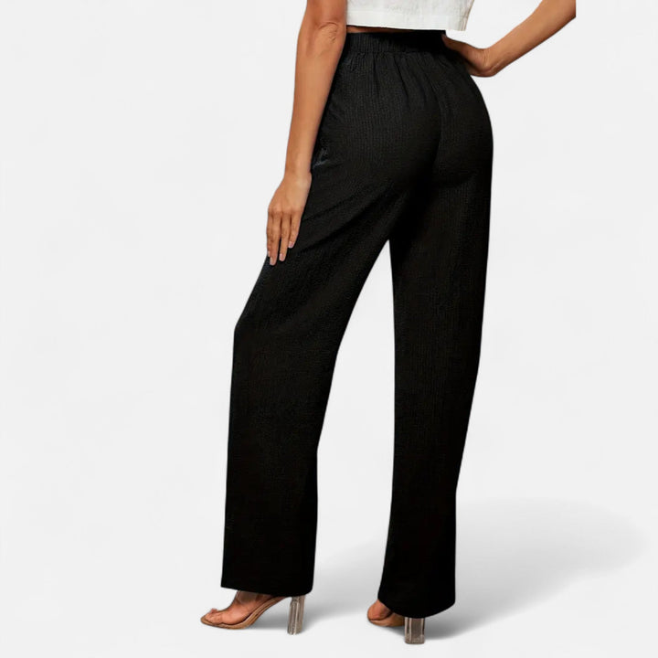 Tailored high-waist straight-leg trousers for women, offering a polished and professional silhouette.