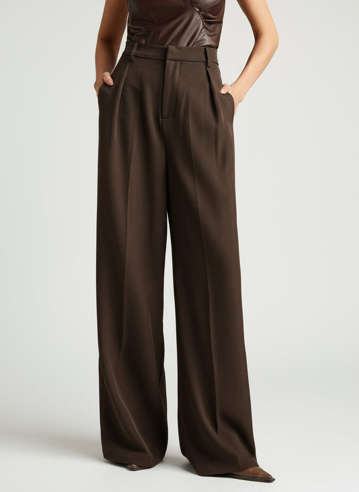 Women's wide leg trousers, high waist, paired with a top for a smart casual look.