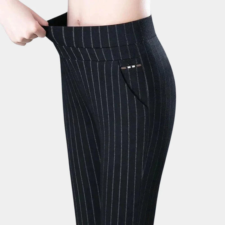 Comfortable women's high-waisted black stretch trousers with elastic waist, ideal for daily wear.