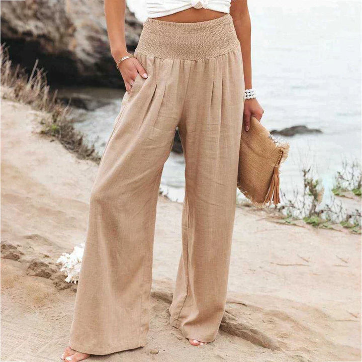 Lightweight high waist smocked linen trousers for women, in a stylish wide leg cut.