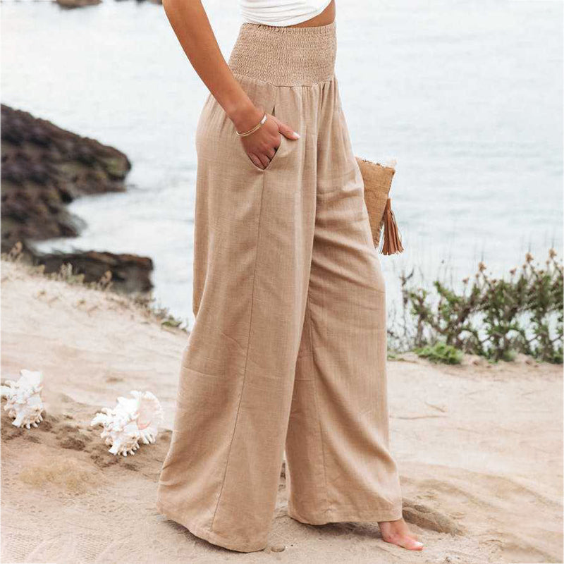 Natural beige women's wide leg linen trousers, perfect for relaxed sunny summer days.