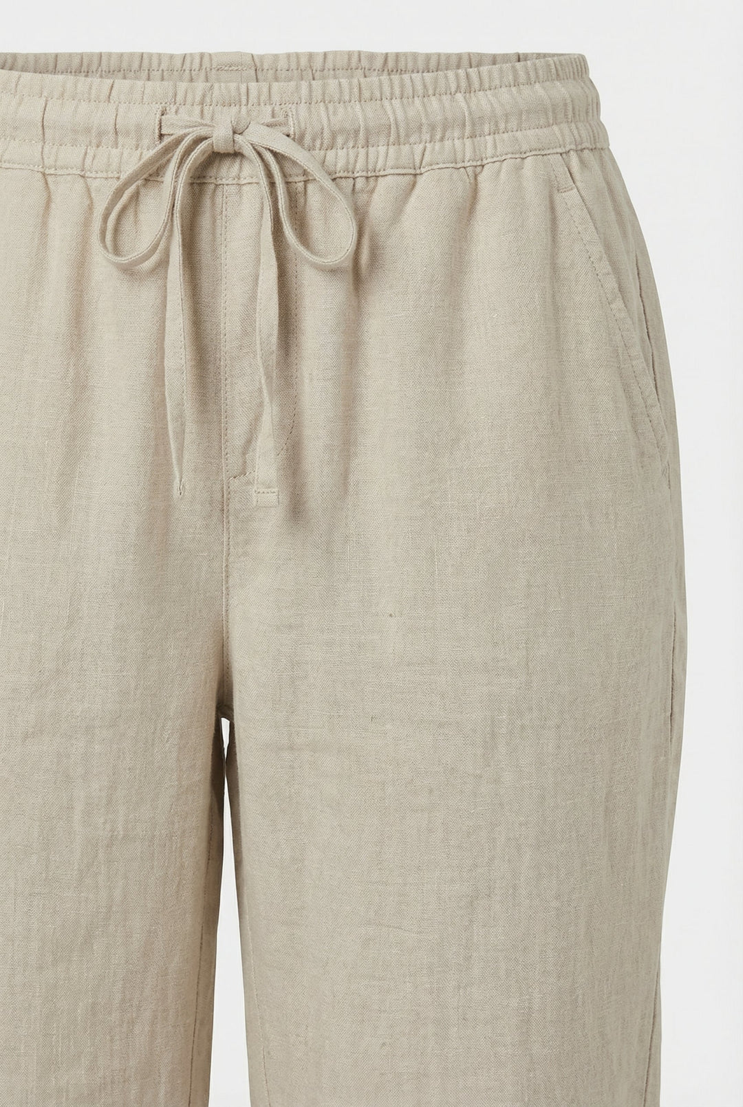 Relaxed fit women's cropped linen trousers featuring an elastic waist & pockets for ultimate comfort.
