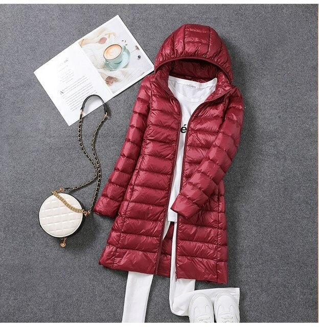 Women's long puffer jacket with a stylish design & practical detachable hood. Ideal warm winter coat for cold weather.