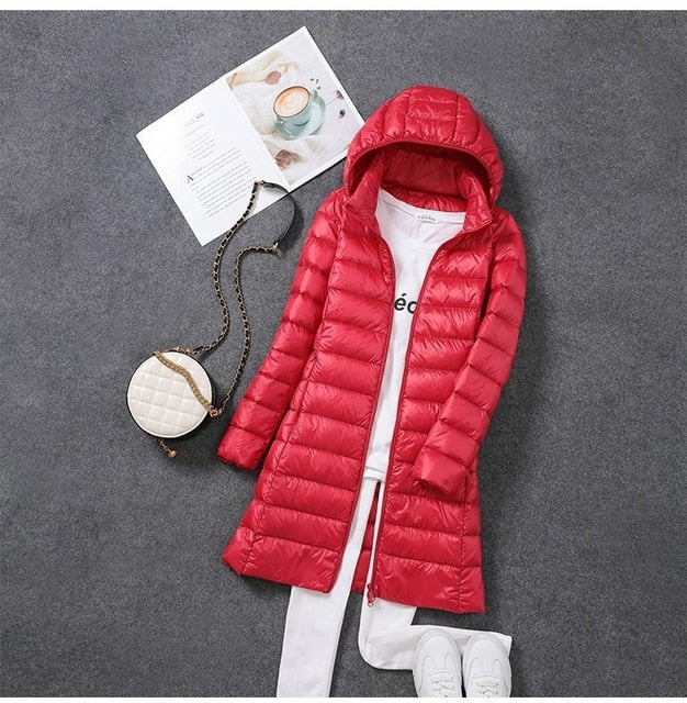 Warm & fashionable women's long puffer jacket. Essential winter coat outerwear with a versatile detachable hood.