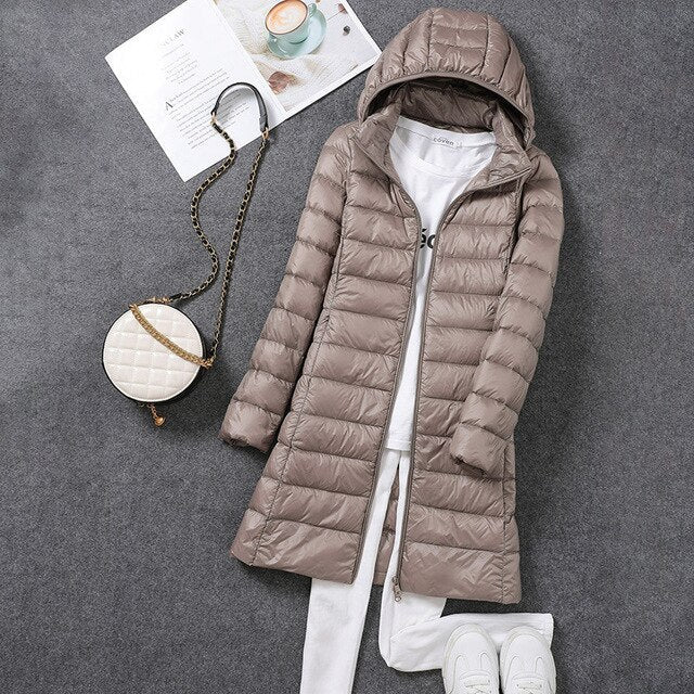 Women's elegant long puffer winter coat, perfect for cold weather. Includes a chic design and a functional detachable hood.
