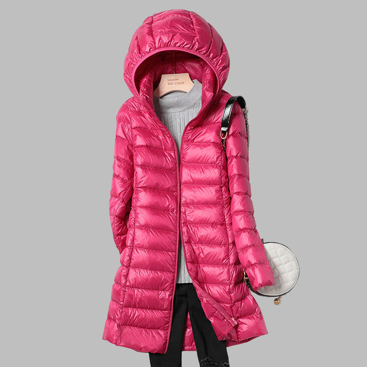 Durable women's long puffer jacket, designed for winter. Features a warm fill & a convenient detachable hood. Great outerwear.