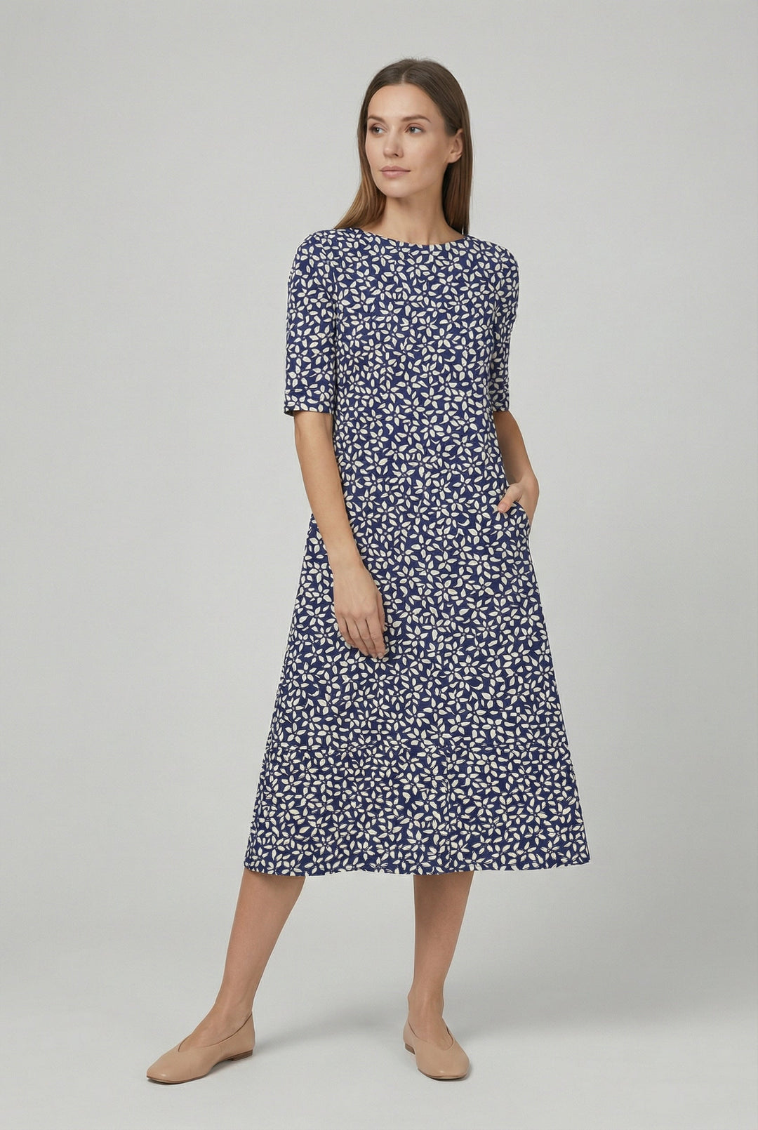 Full length view of a women's vibrant floral midi summer dress, showcasing its relaxed fit and short sleeves.