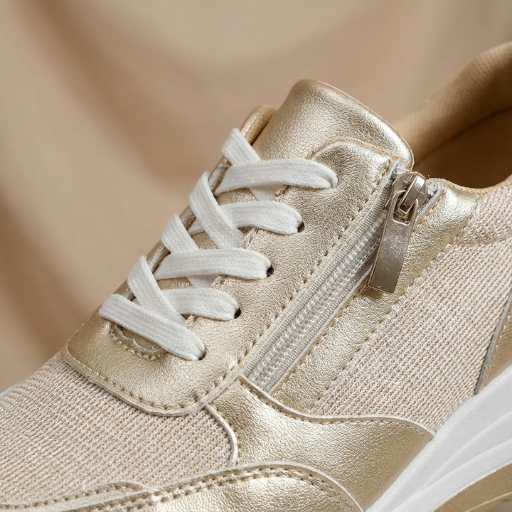 Stylish women's metallic wedge trainers. Fashionable platform sneakers with convenient side zip closure.