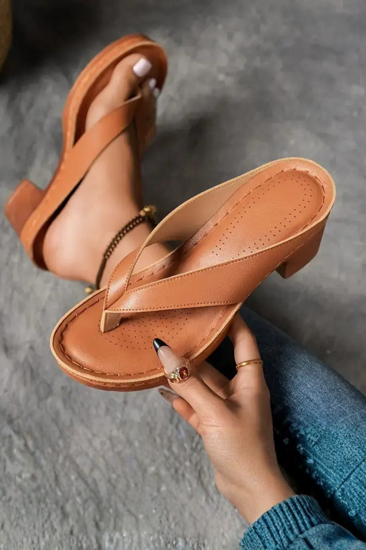 Detail of women's adjustable metallic toe post sandals with a fashionable block heel.