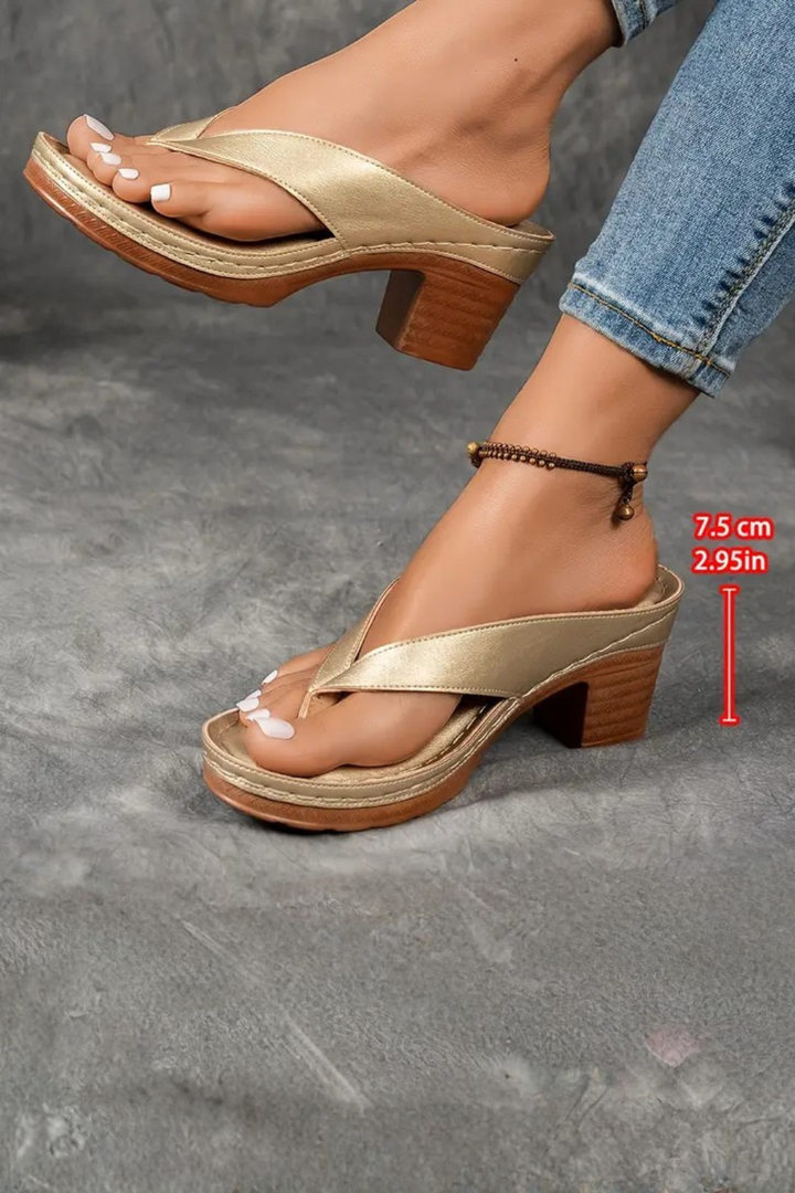 Model wearing elegant women's metallic toe post sandals with block heel, ideal for summer.