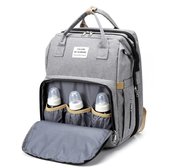 Ergonomic women's multi-function diaper backpack with a practical portable infant sleeping area.