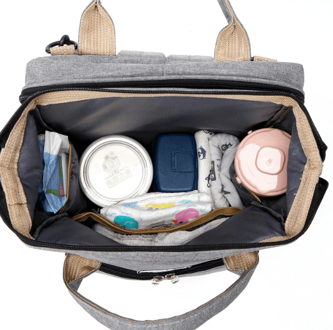Spacious multi-function diaper bag backpack with a secure portable baby bed for travel.