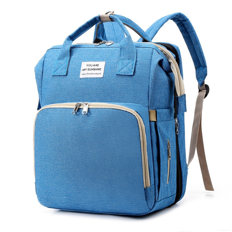 Stylish waterproof multi-function nappy bag and portable baby travel bed for infant essentials.