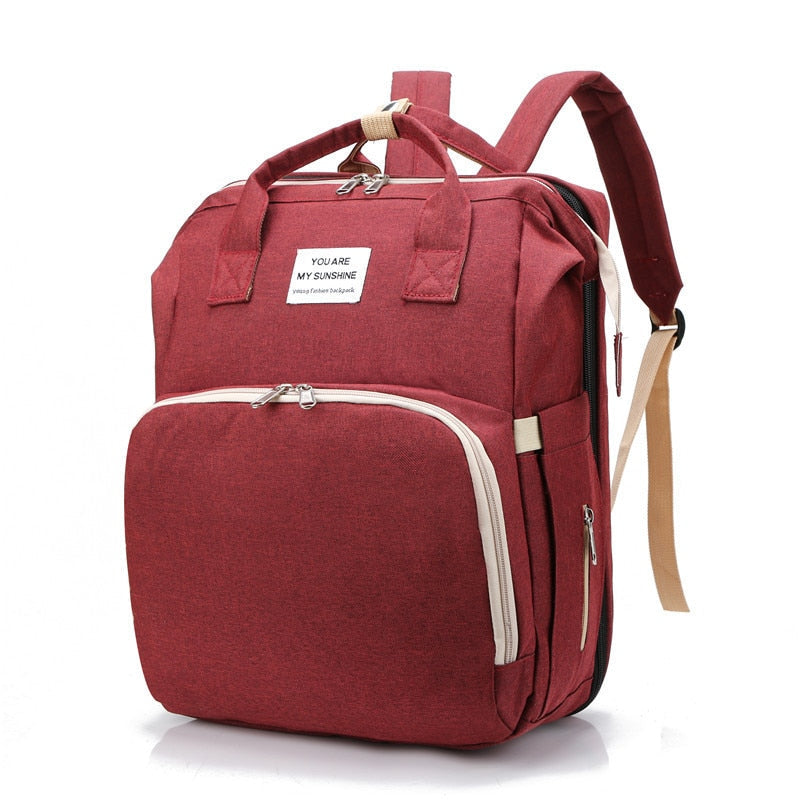All-in-one mom bag: multi-function diaper backpack with portable baby changing station and bed.