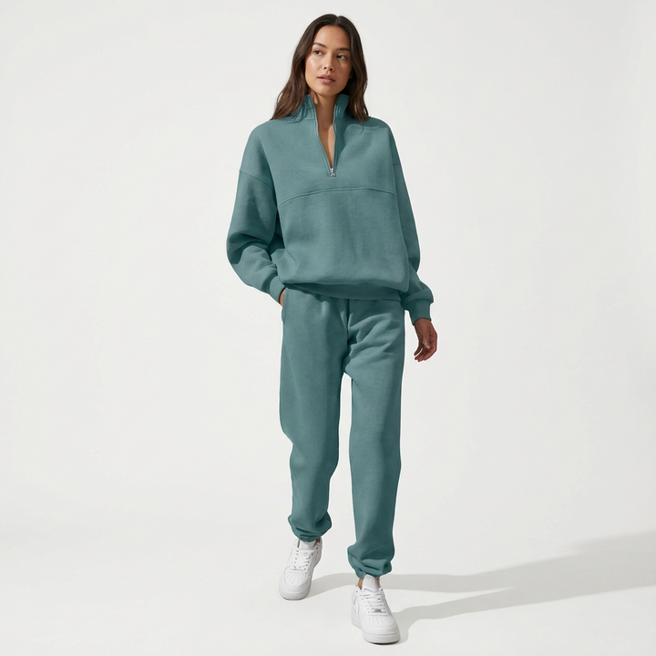 Close-up of a green women's half-zip loungewear top, showcasing the cozy fabric and collar detail.