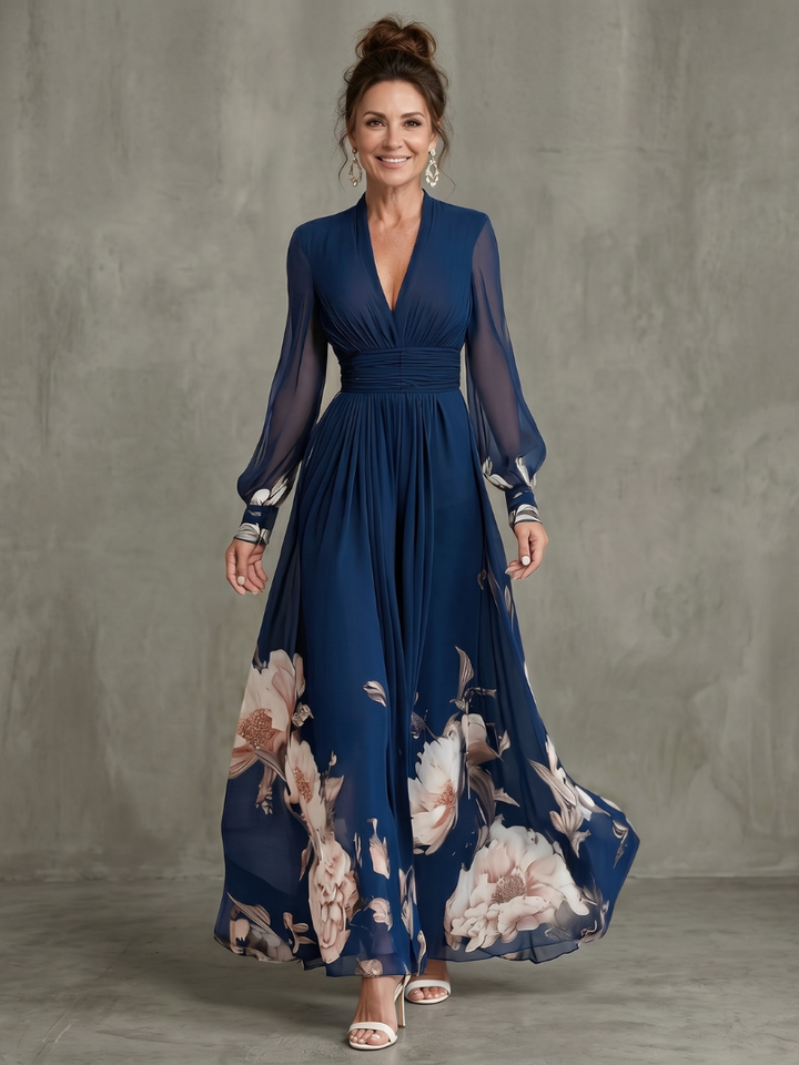 Women's navy pleated maxi dress with elegant sheer long sleeves & V-neck, perfect for evening or formal events.