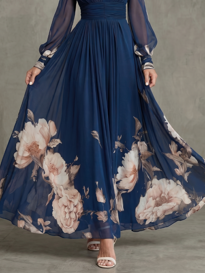 Comfortable women's navy maxi dress, featuring a flattering V-neck, pleated skirt, and delicate sheer sleeves.