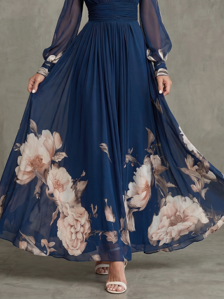 Comfortable women's navy maxi dress, featuring a flattering V-neck, pleated skirt, and delicate sheer sleeves.