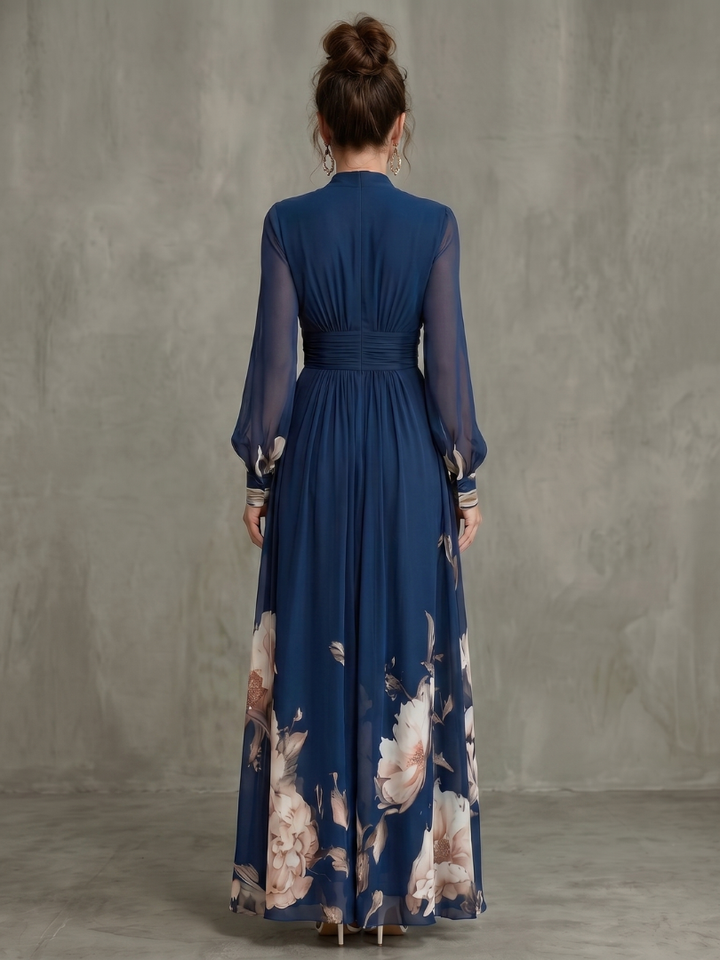 Full-length women's formal pleated maxi dress in navy, showcasing sheer long sleeves & a graceful silhouette.