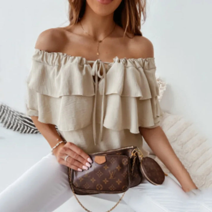 Elegant women's blouse: off-shoulder, long sleeve, tiered ruffles, and a chic tie-front. Feminine and stylish top.