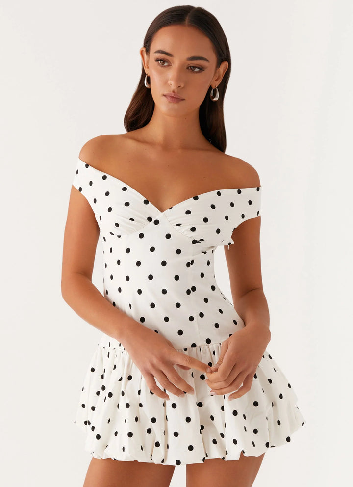 Women's off-shoulder polka dot peplum mini dress, perfect for summer parties.