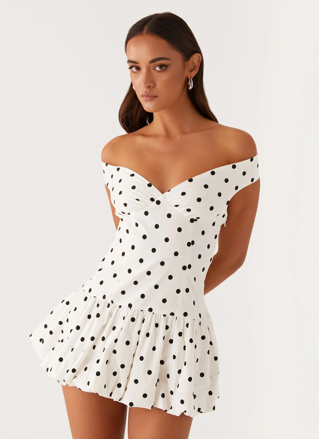 Flattering off-shoulder polka dot peplum mini dress for casual or party wear.