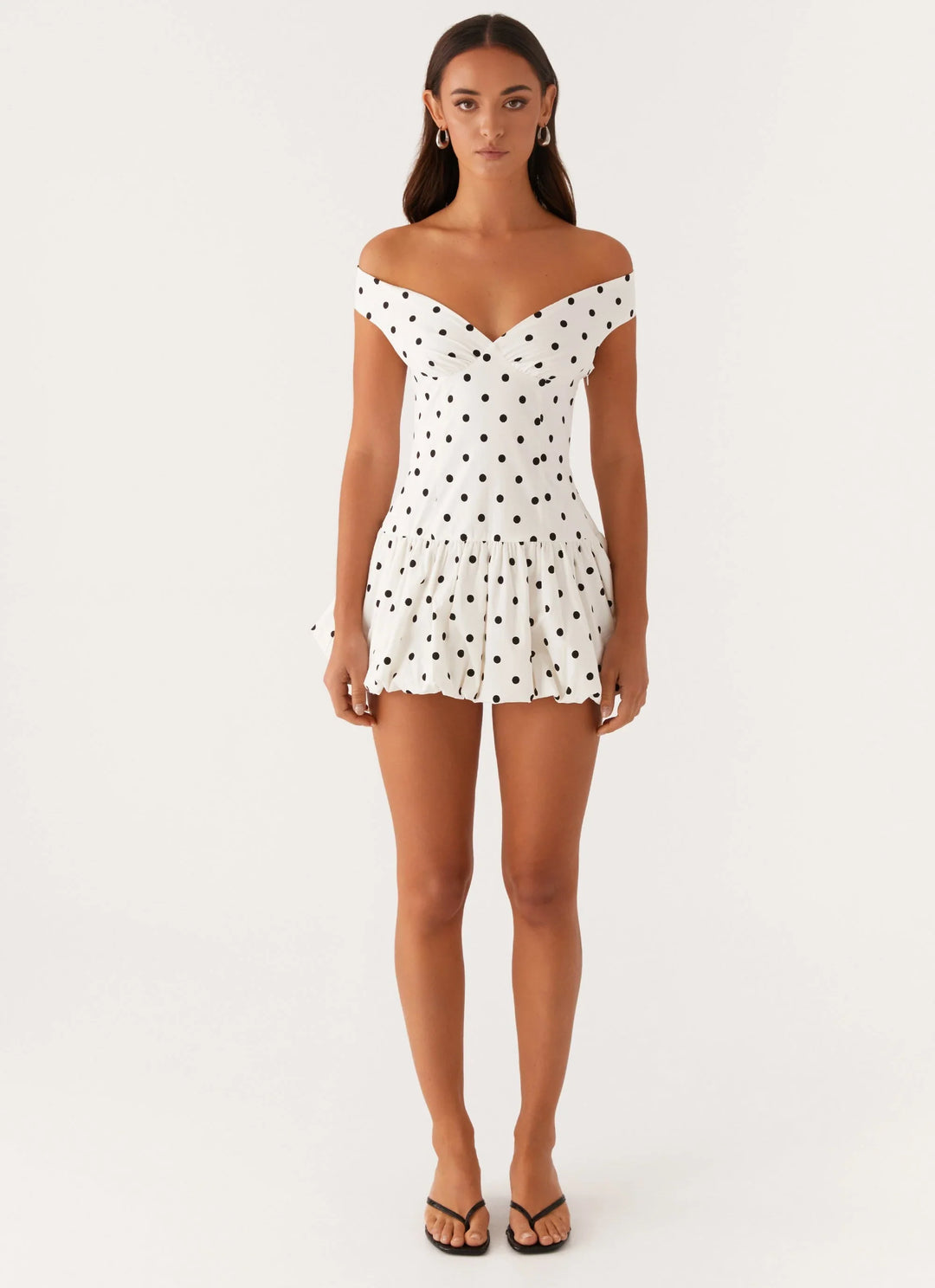 Chic high-waist off-shoulder polka dot peplum mini dress for a flattering silhouette.