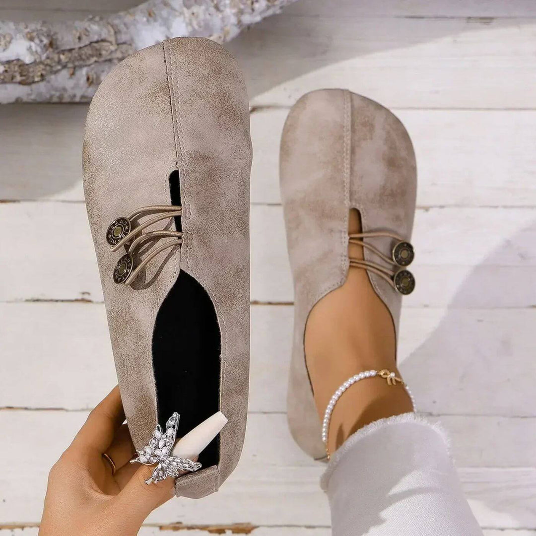 Brown women's supportive orthopedic shoes with arch support, offering cushioned comfort & versatility.