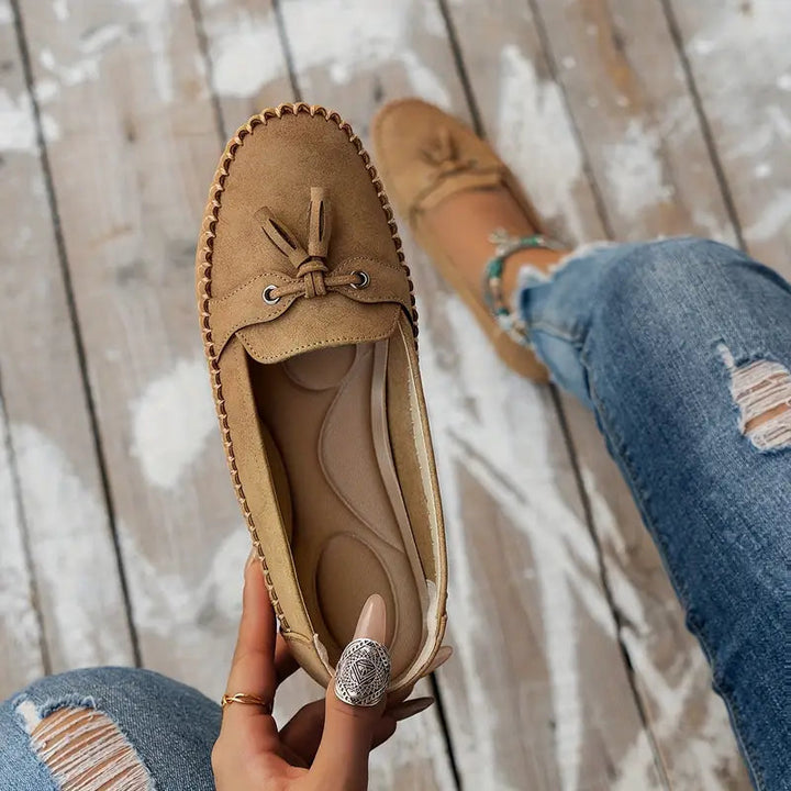Side view of women's orthopedic tassel loafers, showcasing arch support, cushioning & slip-on design.