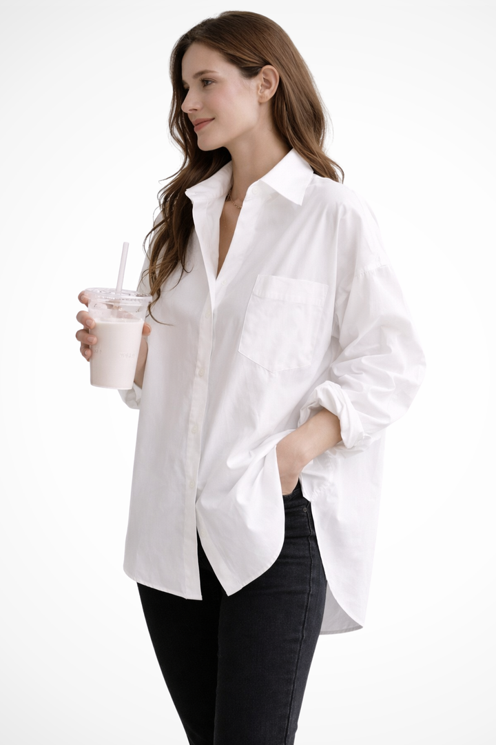 Stylish women's oversized white shirt, a comfortable button-down long-sleeve blouse for casual wear.