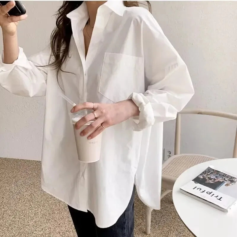 Versatile white oversized blouse with button-down front & long sleeves. Perfect casual top for women's fashion.