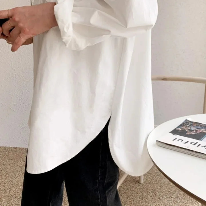 Comfortable women's oversized white shirt, a long-sleeve button-down blouse perfect for versatile styling.