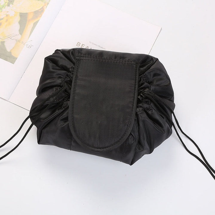Woman packing a portable drawstring toiletry bag for a trip, convenient beauty storage on-the-go.