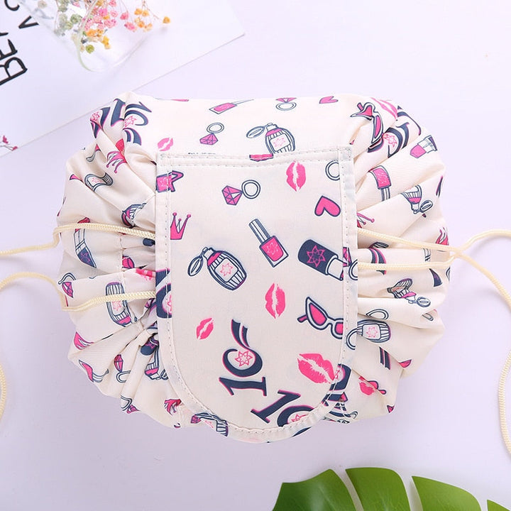 Two grey flamingo drawstring cosmetic bags, illustrating the 1+1 FREE offer for travel organization.