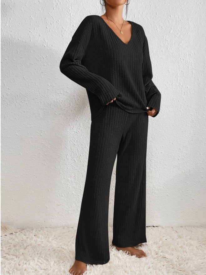 Cozy women's two-piece knit loungewear set. V-neck top and wide-leg ribbed pants for relaxed comfort.