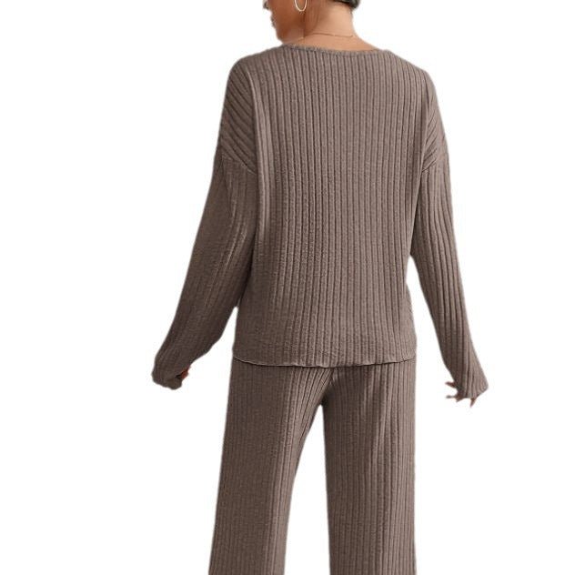 Relaxed women's knit loungewear. Two-piece set with V-neck top & wide-leg ribbed pants for cozy casual style.