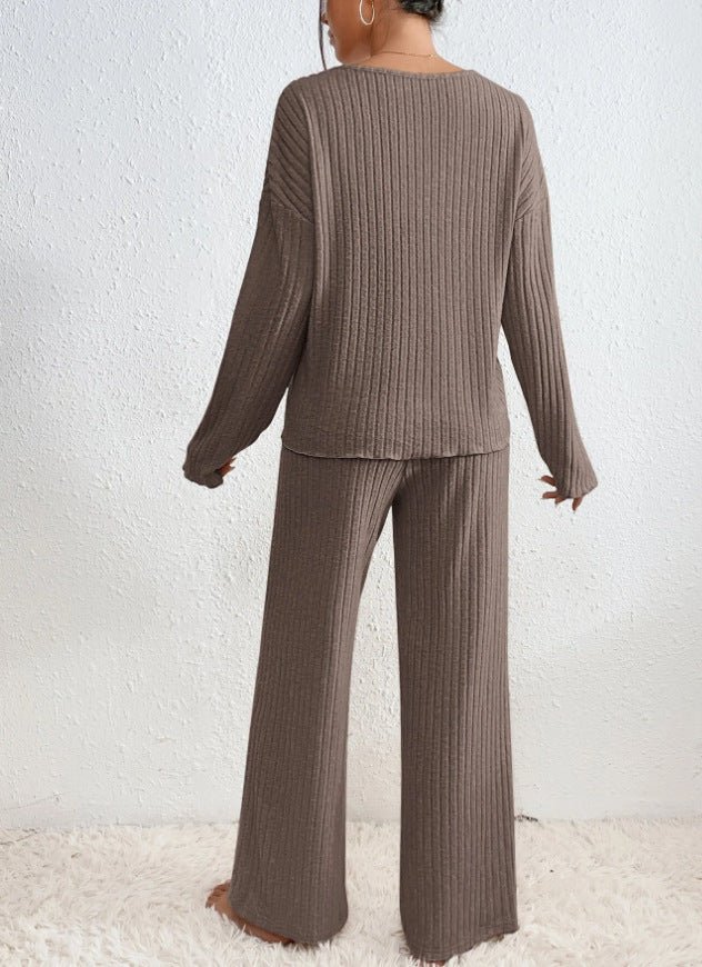 Comfy women's two-piece knit loungewear. Ribbed V-neck top & wide-leg pants, ideal for cozy relaxation.