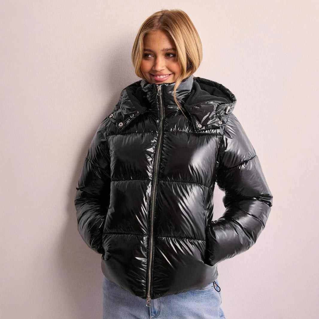 Elegant women's shiny quilted winter jacket. Fashionable outerwear for casual wear with a detachable hood.