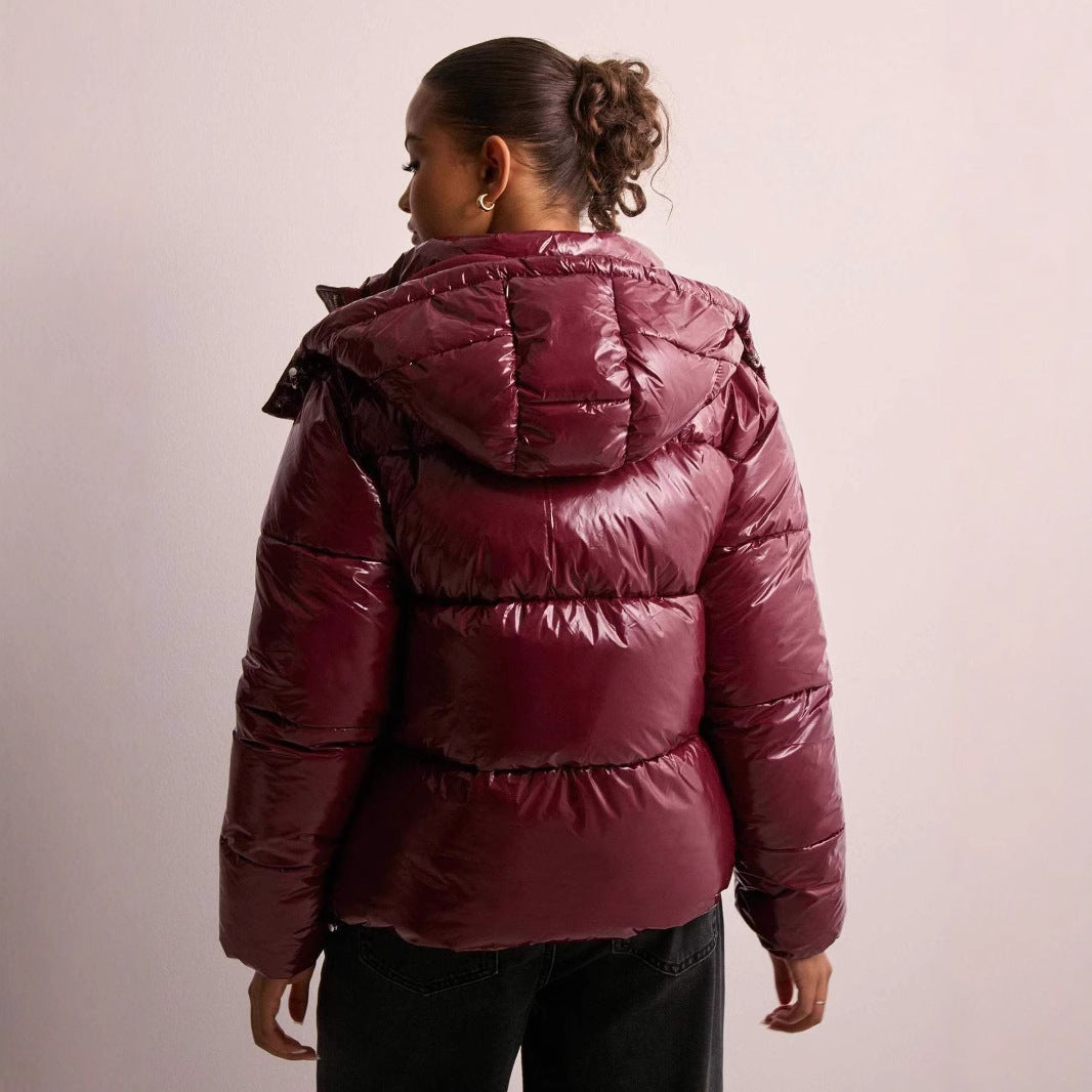 Glossy women's quilted jacket in a stylish design. Chic everyday outerwear with a versatile detachable hood.