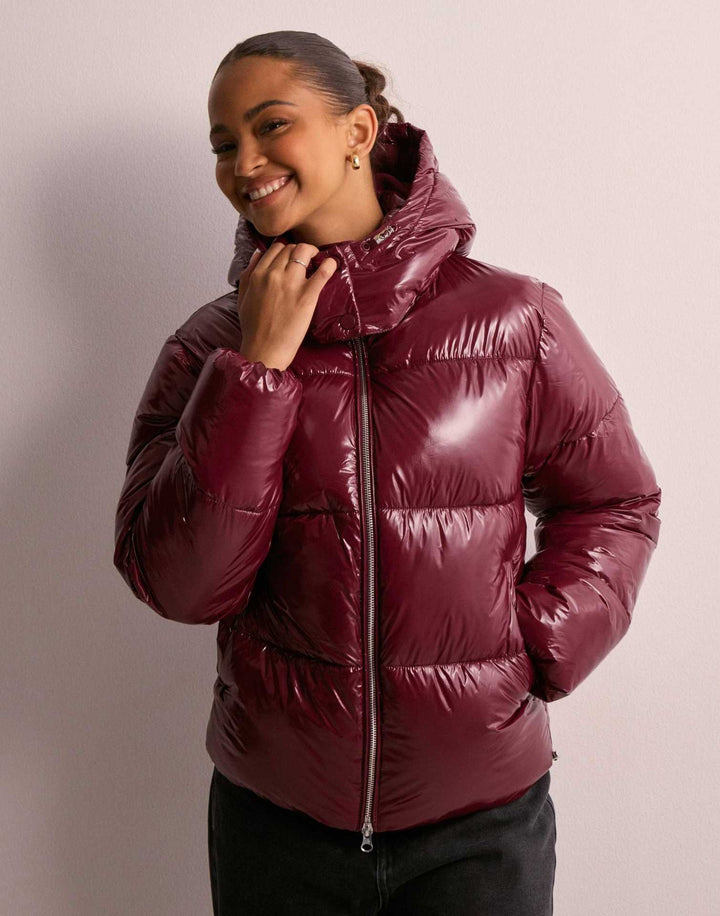 Shimmering women's quilted jacket with a cozy, warm lining. Stylish outerwear & casual coat with removable hood.