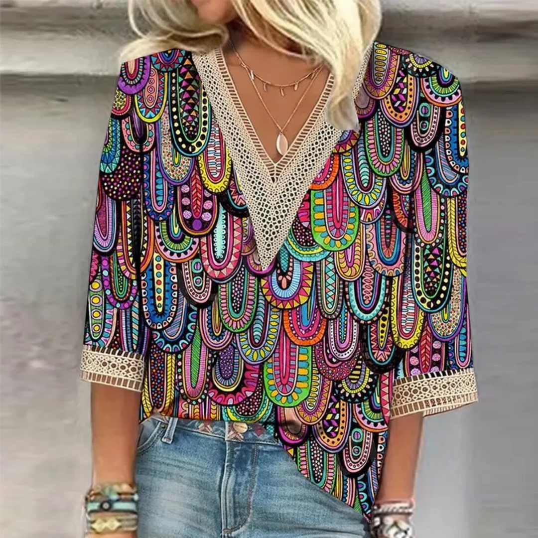 Shimmering V-neck women's blouse with long sleeves, perfect for elegant everyday style.