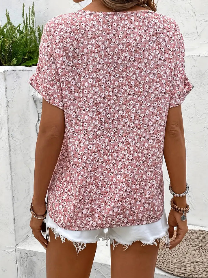 Elegant pink floral print short sleeve button-down blouse, a versatile top for spring and summer fashion.