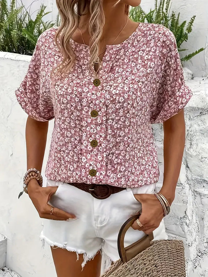Versatile women's short sleeve blouse featuring a vibrant floral print and classic button-down design.
