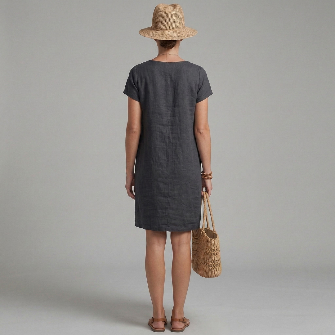 Stylish women's summer mini dress featuring short sleeves and front pockets. Ideal for comfortable, versatile casual fashion.