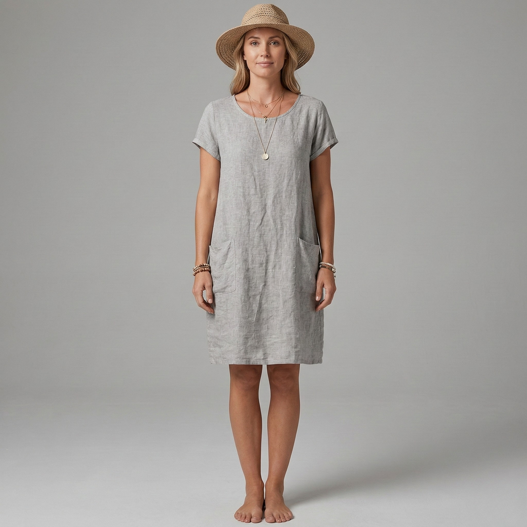 Comfortable women's short sleeve mini dress, perfect for summer. Features useful front pockets and a relaxed casual fit.