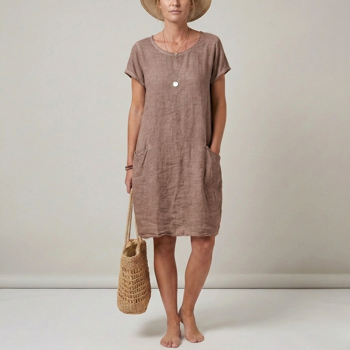 Versatile short sleeve women's mini dress with front pockets. Essential for summer fashion, offering casual comfort.